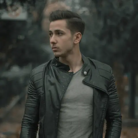 Customer in a black biker jacket outdoors in autumn