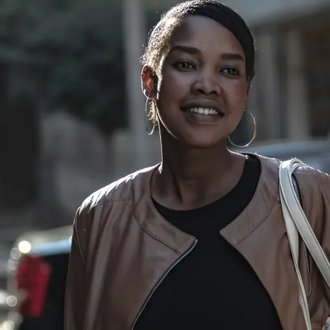 Customer in a tan leather jacket, smiling
