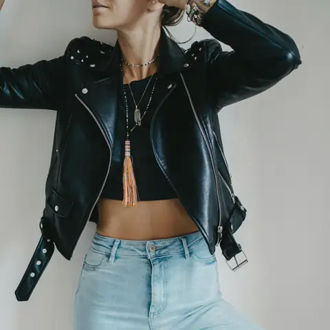 Customer in a cropped black biker jacket with studded shoulders