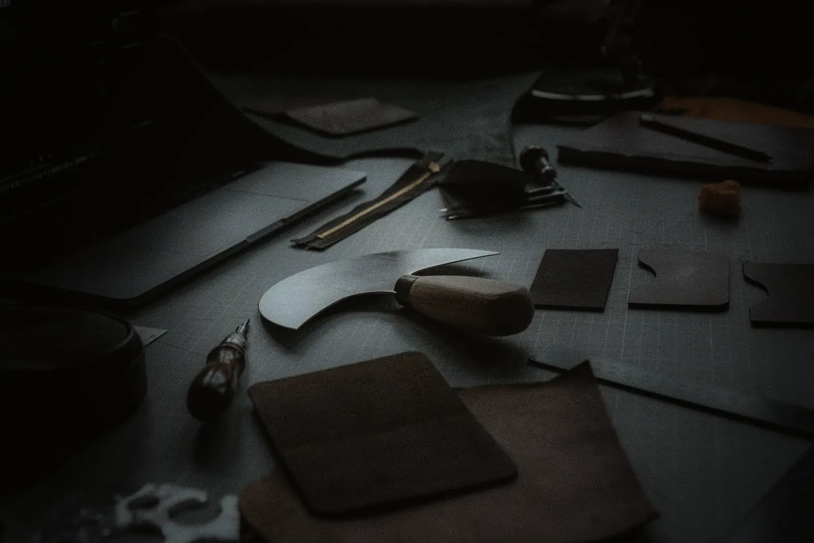 Cutting tools and leather offcuts on a workbench